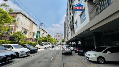 View of apartment building exterior with parking area