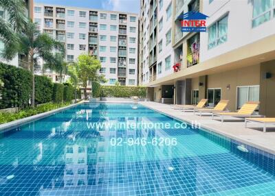 Swimming pool area with apartment buildings in the background