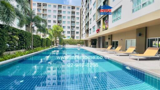 Swimming pool area with apartment buildings in the background