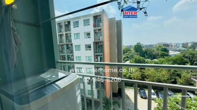 Balcony view of neighboring buildings and greenery