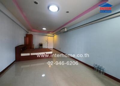 Spacious living area with tiled floors and accent lighting