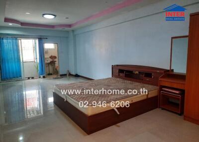 Spacious bedroom with large windows and furniture