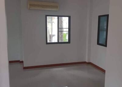 Empty living room with windows and air conditioner