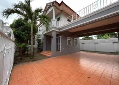 Two-story house with a large tiled driveway