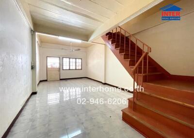 Room with staircase and tiled flooring