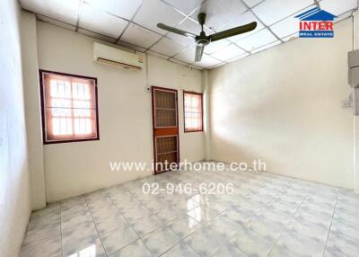 Spacious bedroom with tiled floor, ceiling fan, and air conditioner unit