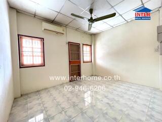 Spacious bedroom with tiled floor, ceiling fan, and air conditioner unit