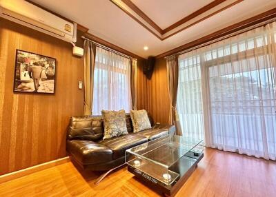 Cozy living room with leather sofa and glass coffee table