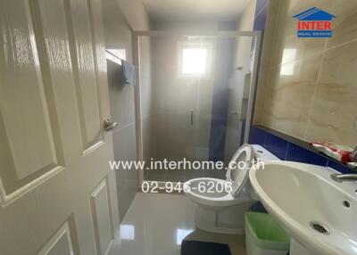 Modern bathroom with white fixtures and walk-in shower