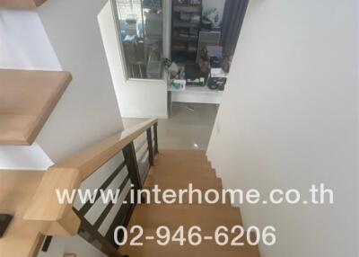 Staircase view leading to a lower floor with a home office