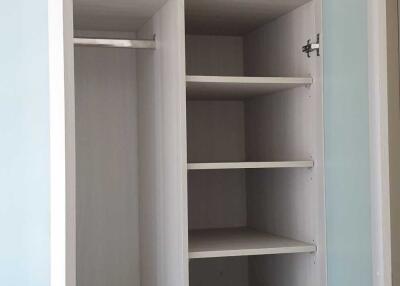 Open closet with various shelves and compartments