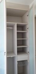 Open closet with various shelves and compartments