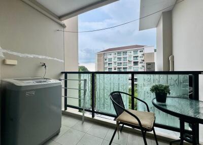 Balcony area with outdoor seating and washing machine