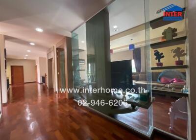 Spacious hallway with glass partition and wooden flooring