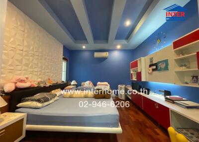 Cozy bedroom with blue walls and hardwood floor