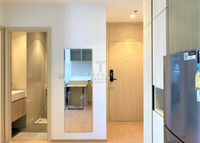 Entryway with Bathroom, Mirrored Wall, and Kitchen in View