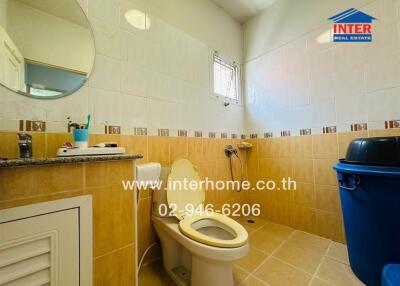 Bright bathroom with tiled walls and toilet