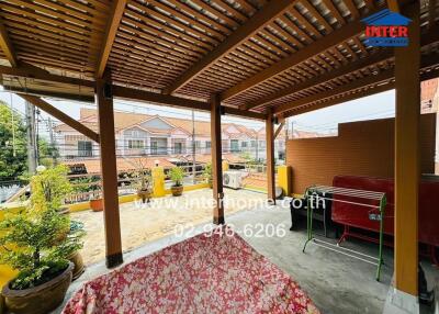 Covered patio with wooden pergola and seating area