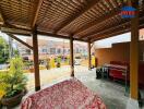 Covered patio with wooden pergola and seating area