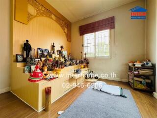 Room featuring a display of various items and a decorated wooden structure