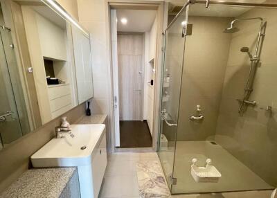 Modern bathroom with glass shower and white fixtures