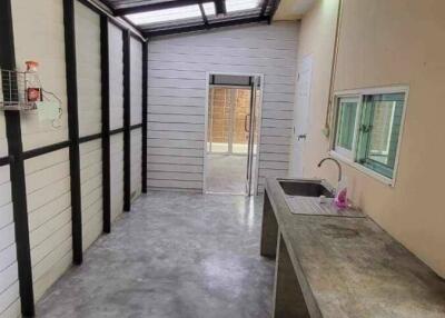 Modern minimalist kitchen with concrete countertop and stainless steel sink