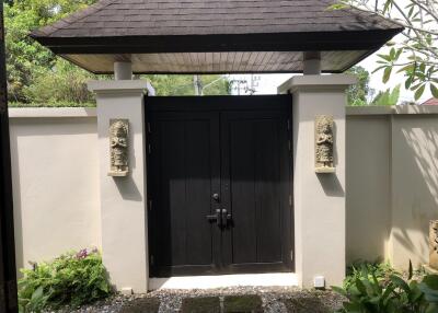 Gate with a covered entrance in a garden