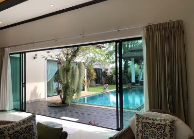 Living area with a view of the outside garden and pool