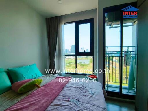 Bright bedroom with large window and balcony view