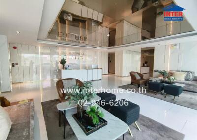 Modern lobby area of a residential building with seating and reception desk