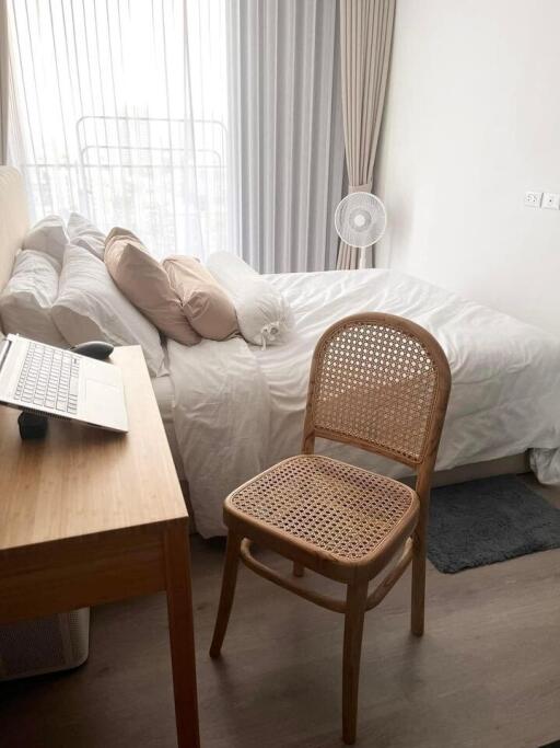 Bedroom with bed, desk, chair and large window