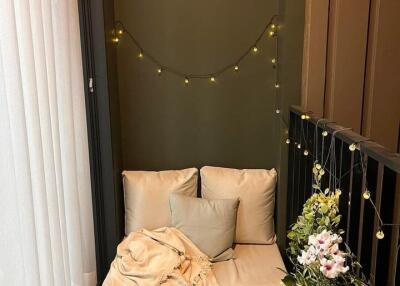 Cozy balcony with seating area and string lights