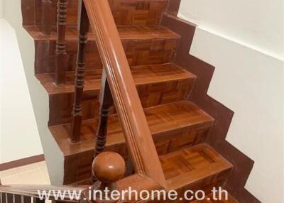 Wooden staircase with handrail in home interior