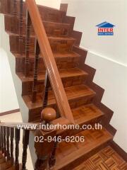 Wooden staircase with handrail in home interior