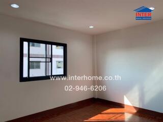 Bedroom with window and hardwood floors