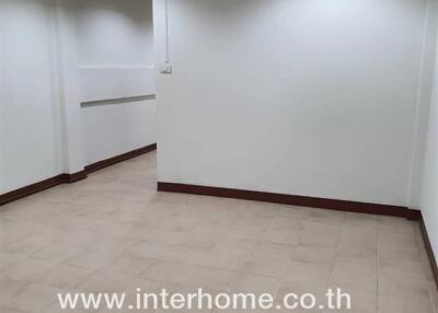 empty room with tiled floor and white walls