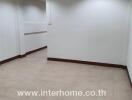 empty room with tiled floor and white walls