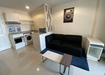 Modern studio apartment with living area and kitchen