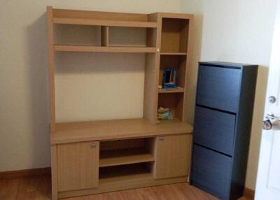 Small room with wooden shelves and a closed cabinet