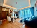 Modern living room with dining area and full-length window drapes