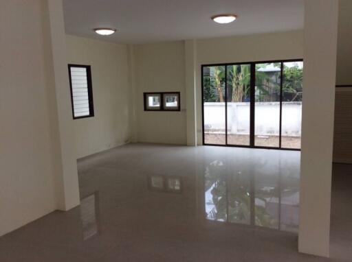 Spacious empty living room with large windows and natural light