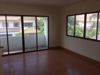 Spacious living room with large windows and balcony access