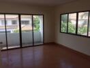 Spacious living room with large windows and balcony access