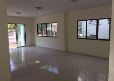 Spacious living area with large windows and natural lighting