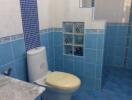 Bathroom with blue tiles and shower