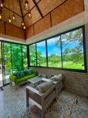 Spacious living room with large windows and garden view