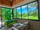 Spacious living room with large windows and garden view