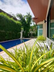 Poolside view with lush greenery