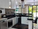 Modern kitchen with stainless steel appliances and bar seating