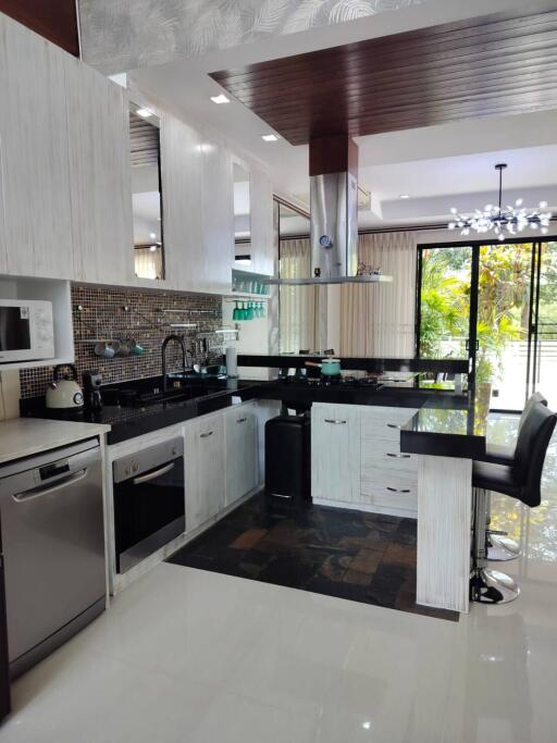Modern kitchen with stainless steel appliances and bar seating